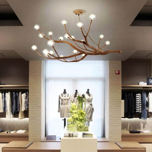 Rustic Tree Branch Pendant Light on ceiling of clothes store
