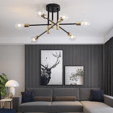 Load image into Gallery viewer, Black & Gold LED Chandelier above corner sofa in living room