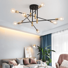 Load image into Gallery viewer, Black & Gold LED Chandelier above table in living room