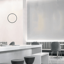 Load image into Gallery viewer, Black LED Single Ring Pendant Light above table in cafe
