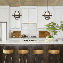 Load image into Gallery viewer, Two Rustic Globe Chandeliers hanging above kitchen island
