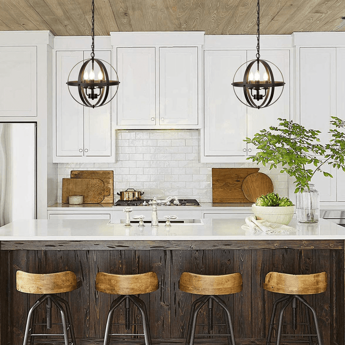 Two Rustic Globe Chandeliers hanging above kitchen island