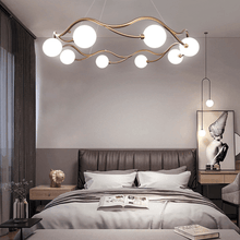 Load image into Gallery viewer, Circular Wave Chandelier above bed in bedroom
