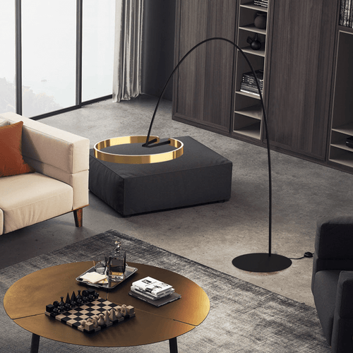 Gold Creative Designer Ring Floor Lamp in living room leaning over coffee table with chess board on
