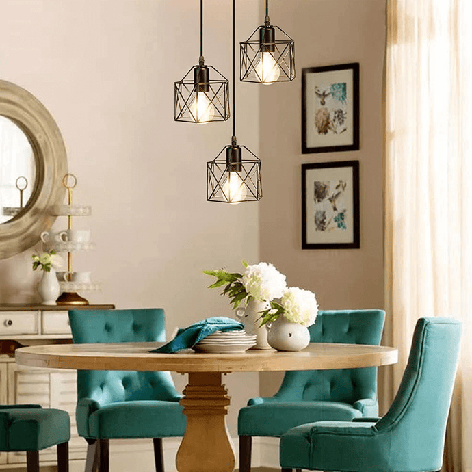 Scandinavian Triple Lamp Chandelier hanging above living room table with green chairs