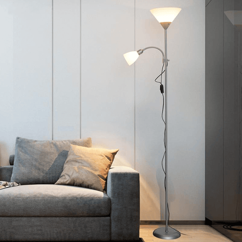 Silver Two-Headed Industrial Floor Lamp next to sofa in living room