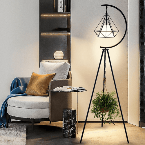 Black Nordic Triangle Tripod Floor Lamp next to armchair in living room