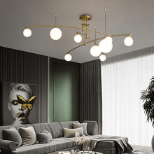Load image into Gallery viewer, Gold Modern Long Arm Chandelier above sofa in living room
