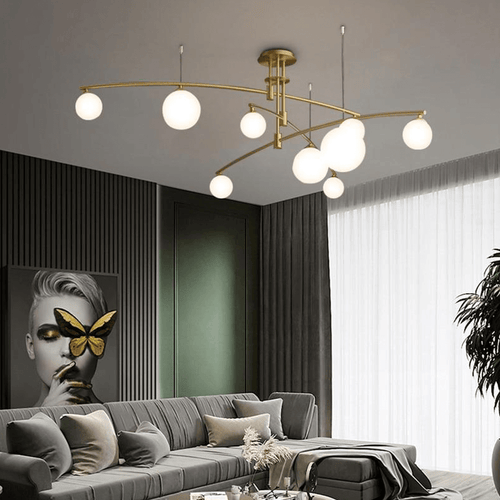 Gold Modern Long Arm Chandelier above sofa in living room