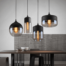 Load image into Gallery viewer, Black Modern Glass Pendant Lamps above living room table

