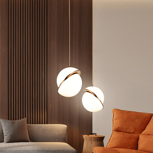 Two Nordic Globe Pendant Lamps above orange sofa in living room