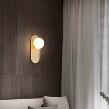 Load image into Gallery viewer, Gold Flat Base Globe Light above bed on brown wall
