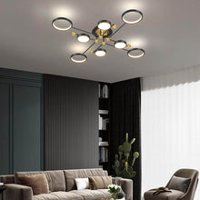 Load image into Gallery viewer, Black Modern Neutral Chandelier above sofa and armchair in living room
