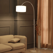 Load image into Gallery viewer, White Modern Essential Floor Lamp leaning over sofa in living room

