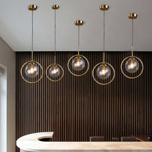 Load image into Gallery viewer, Five Modern Glass Ball Pendant Lights above reception desk
