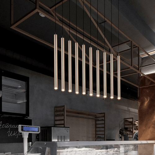 Gold Nordic Tube Pendant Lights above bakery counter