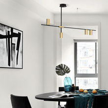 Load image into Gallery viewer, Scandinavian Long Arm Chandelier hanging from ceiling above black dining table
