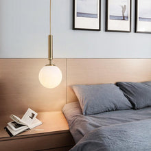 Load image into Gallery viewer, Gold Glass Ball Pendant Lamp above bedside table
