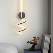 Load image into Gallery viewer, Black Nordic Spiral Wall Light above bedside table in bedroom
