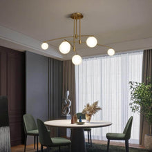 Load image into Gallery viewer, Gold Modern Long Arm Chandelier above living room table
