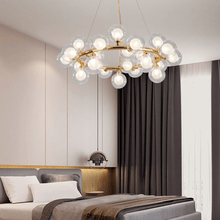 Load image into Gallery viewer, Magic Globe Chandelier hanging from bedroom ceiling above double bed
