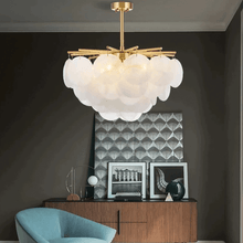 Load image into Gallery viewer, Modern Artistic Gold Chandelier above armchair in living room
