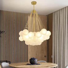 Load image into Gallery viewer, Gold Frosted Glass Ball Chandelier above living room table
