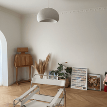 Load image into Gallery viewer, Japanese Style Pebble Pendant Light above white armchair in living room
