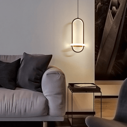 Black Scandinavian LED Pendant Light above coffee table next to sofa in living room