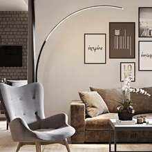 Load image into Gallery viewer, Black Nordic Arc Floor Lamp overlooking sofa in living room with armchair
