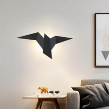 Load image into Gallery viewer, Black Metallic Bird Wall Light on living room wall above coffee table
