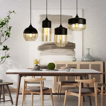 Load image into Gallery viewer, Black Modern Glass Pendant Lamps above living room table
