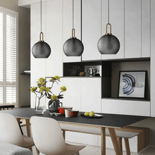 Load image into Gallery viewer, Smoky Glass Pendant Lights above living room table
