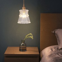 Load image into Gallery viewer, Crystal Pendant Lamp hanging above bedside table with small flower on top
