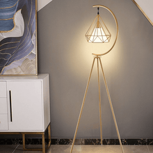 Load image into Gallery viewer, Gold Nordic Triangle Tripod Floor Lamp next to cabinet in living room
