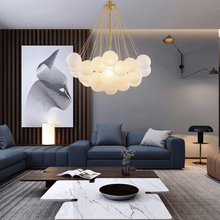 Load image into Gallery viewer, Gold Frosted Glass Ball Chandelier above living room

