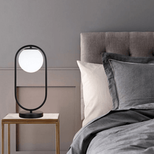 Load image into Gallery viewer, A black Modern Golden Globe Table Lamp on a bedroom table
