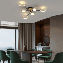 Load image into Gallery viewer, Gold Modern Neutral Chandelier above dining room table in high-rise apartment
