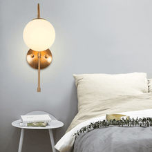 Load image into Gallery viewer, Modern Globe Wall Lamp on bedroom wall above bedside table
