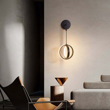 Load image into Gallery viewer, Black Modern Luxury Ring Wall Light in living room above deck chair
