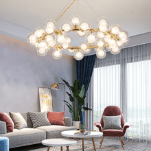 Load image into Gallery viewer, Magic Globe Chandelier above living room coffee tables
