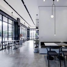 Load image into Gallery viewer, Industrial Pendant Light above dining table in cafe
