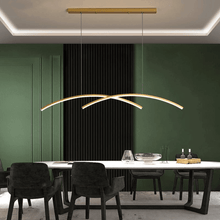 Load image into Gallery viewer, Gold Curved Oscillating Strip Chandelier above dining room table
