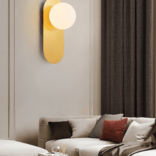 Load image into Gallery viewer, Gold Flat Base Globe Light on wall above sofa
