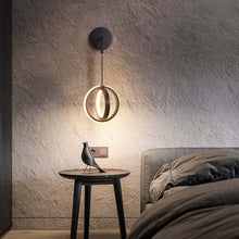 Load image into Gallery viewer, Black Modern Luxury Ring Wall Light above bedside table in bedroom
