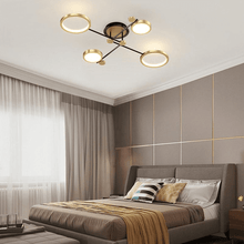 Load image into Gallery viewer, Gold Modern Neutral Chandelier above bed in bedroom
