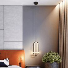 Load image into Gallery viewer, Black Scandinavian LED Pendant Light hanging above bedside table
