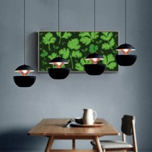 Load image into Gallery viewer, Black Modern Globe Pendant Lights above table
