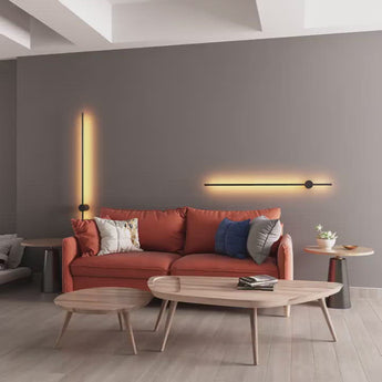 Nordic LED Pole Lights on living room wall behind orange sofa