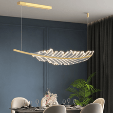 Load image into Gallery viewer, Gold Modern Leaf-Shaped Chandelier above dining table with white chairs

